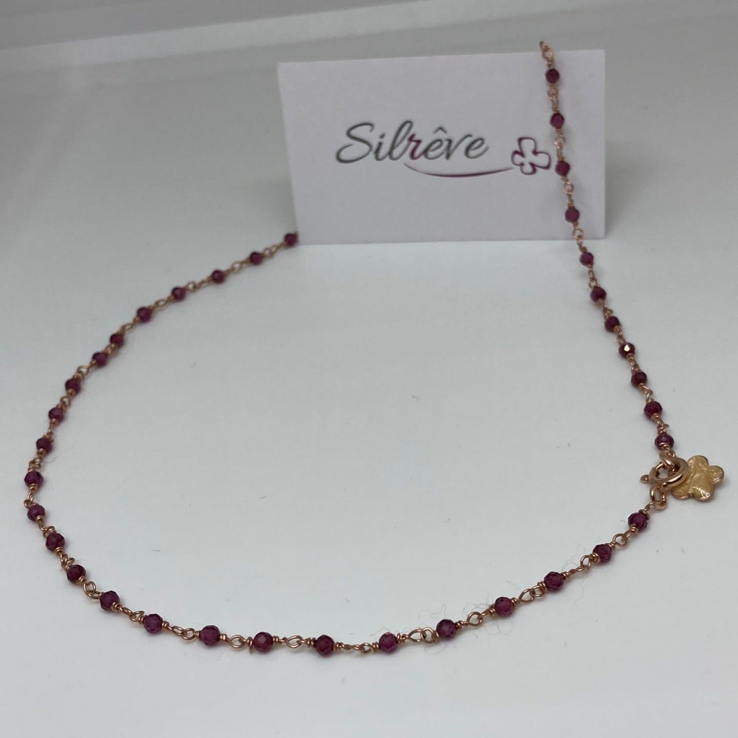Girocollo 'nodo orefice' in Ag. 925 rosato, con pietre preziose
