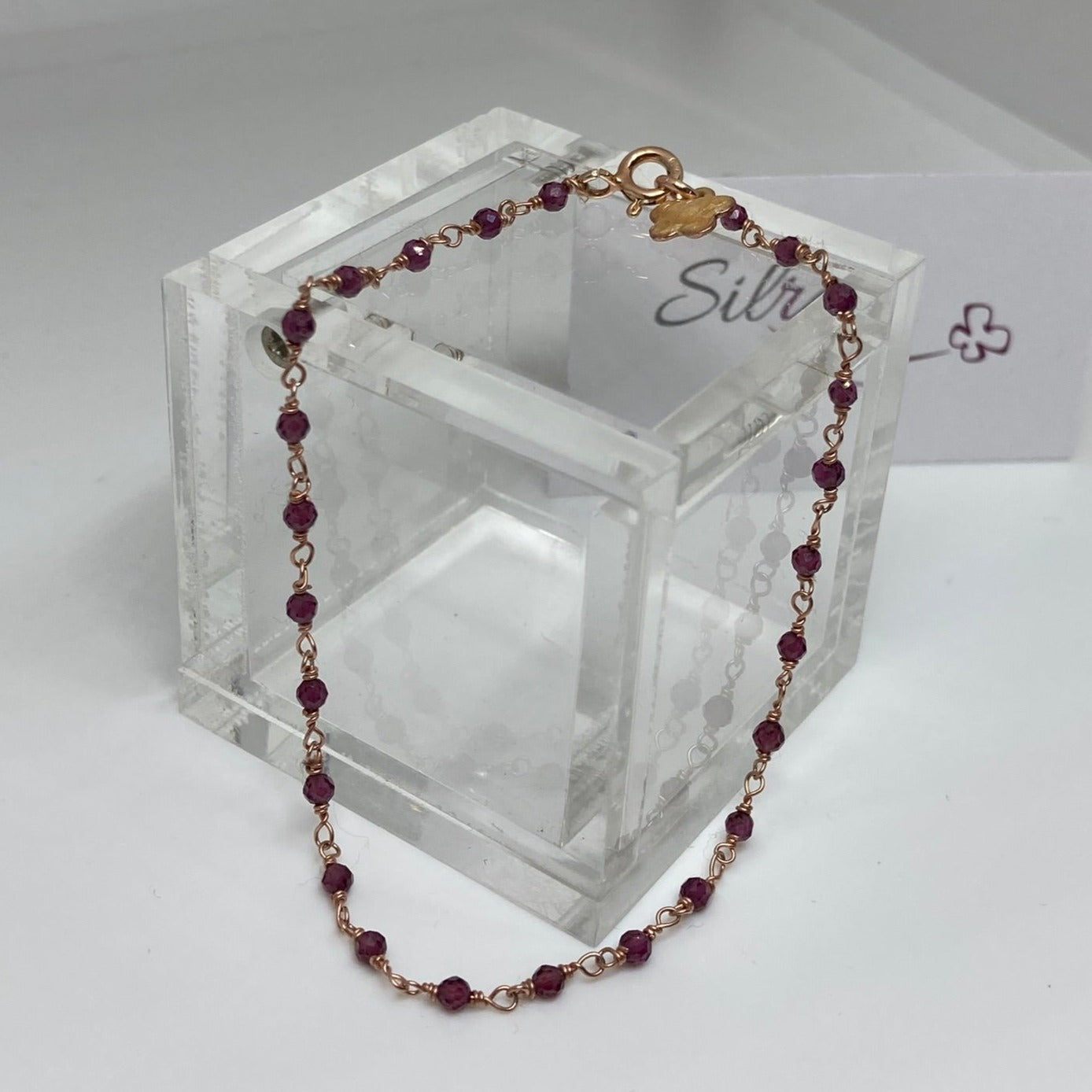 Braccialetto 'nodo orefice' in Ag. 925 rosato, con pietre preziose